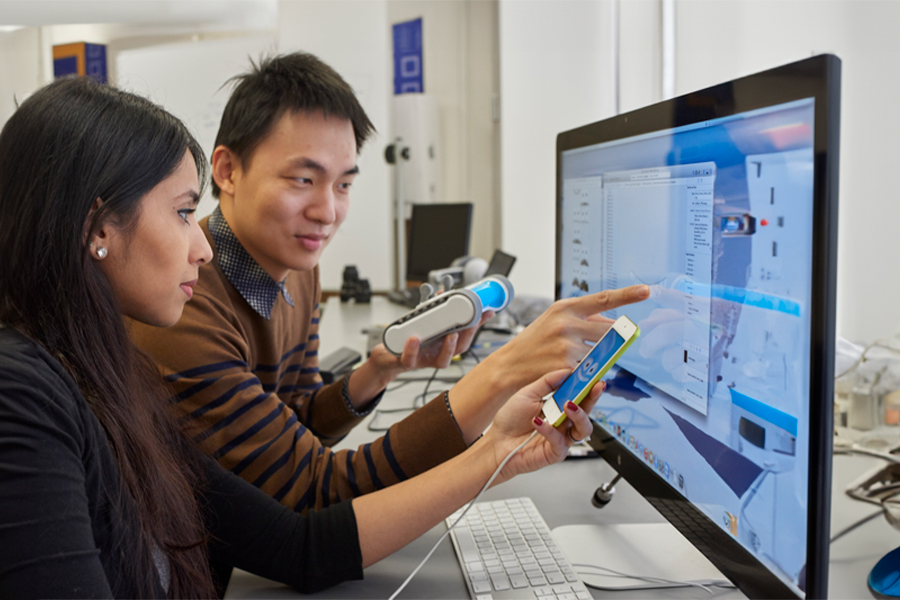 Student and professor looking at computer screen.