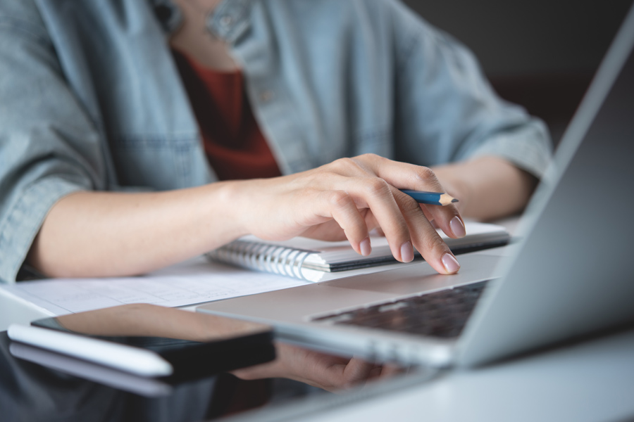 a woman's hand scrolling on a computer trackpad