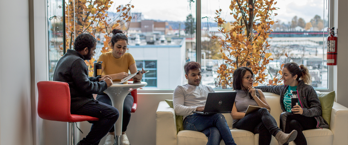 Students hanging out on a couch at the Vancouver campus.