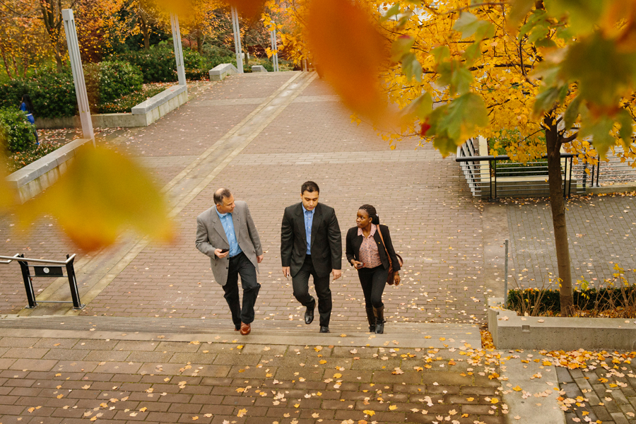 Three students walk around campus.